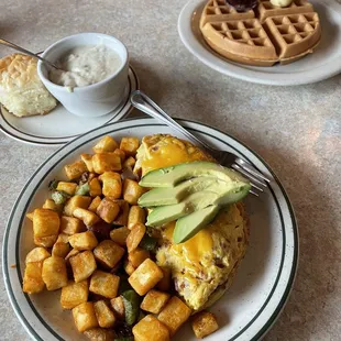 Bacon, Avocado, &amp; Tomato Omelette with country potatoes and biscuit &amp; gravy. With a waffle on the side