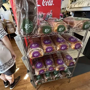 a woman standing in front of a cart of donuts