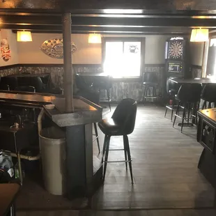 a bar with stools and tables