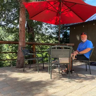 Patio seating with a beautiful view of trees and grass!