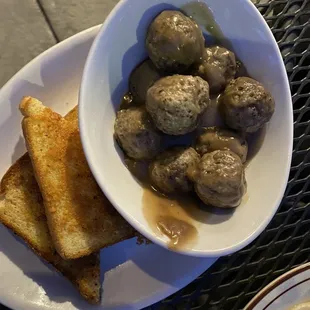 Dry Swedish Meatballs on top and moist balls on the bottom with a side of &apos;garlic&apos; bread (really soaked in oil or popcorn butter)
