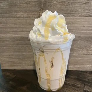 a cup of ice cream with whipped topping