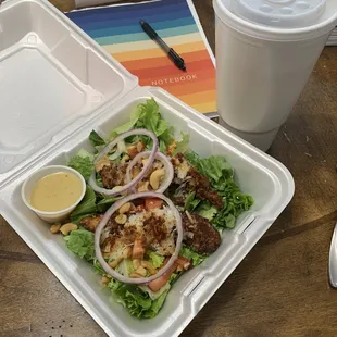 a salad in a styrofoam container