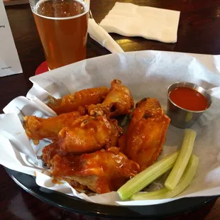 Buffalo wings with a side of buffalo sauce.