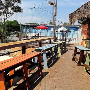 a row of wooden benches on a deck