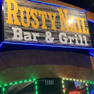 the neon sign for rusty nail bar and grill