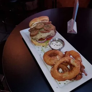 Burger topped with boudain chips and onion rings