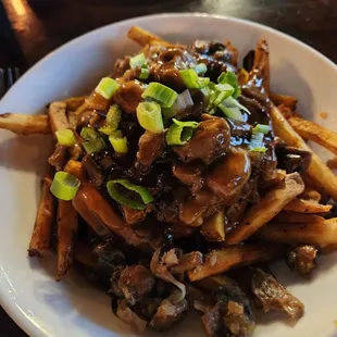 OPen faced burger on fries with a mushroom gravy