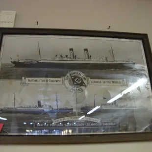 A large framed vintage advertising print.