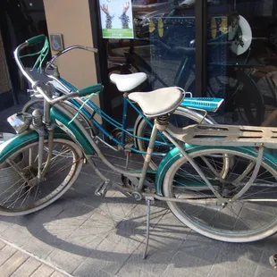 Some vintage bicycles on display outside.