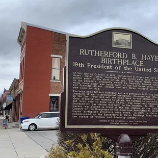 a historical plaque in front of the restaurant