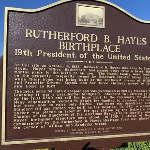 the historical plaque on the side of the building
