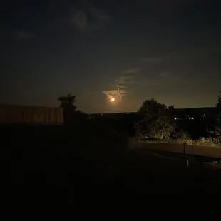 Harvest moon over a picnic table.