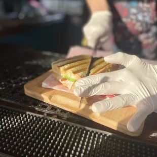a person preparing a sandwich