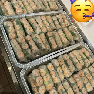 two trays of shrimp wrapped in plastic