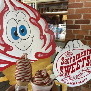 two people holding up ice cream cones