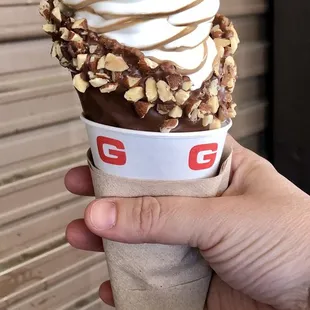 a hand holding an ice cream cone