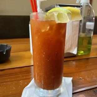 a bloody drink with a slice of lemon