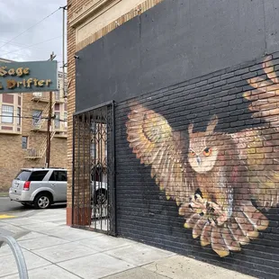an owl painted on the side of a building