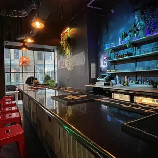 a bar with red stools