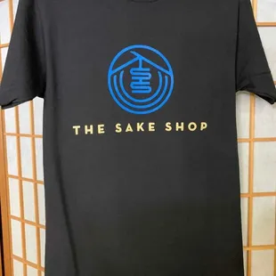 the sake shop logo on a black t - shirt