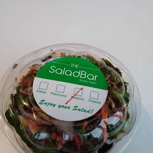 a salad in a plastic bowl