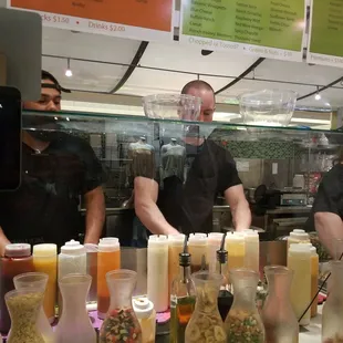 two men preparing salads