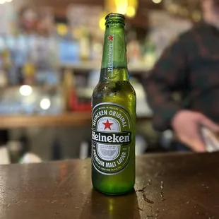 a bottle of heineken beer on a table