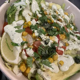 Rice bowl with mango, corn, avocado and all the standard fixings and the avocado lime crema on top.