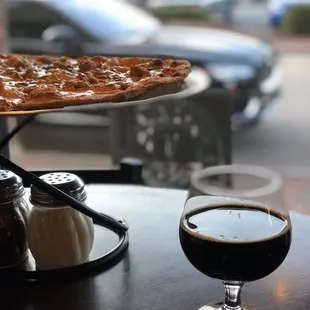 Awesome pizza and brew! Pretty sweet ride in background.