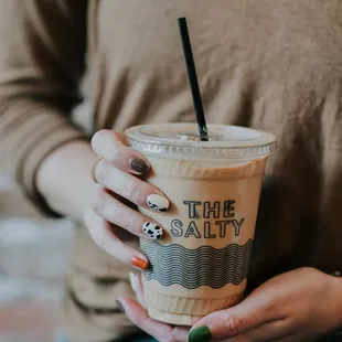 a woman holding a cup of coffee