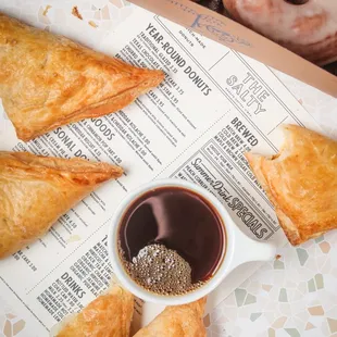 a box of pastries and a cup of coffee