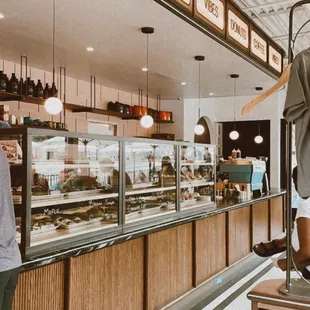 a man standing in a donut shop