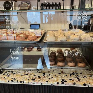 a variety of donuts in a display case