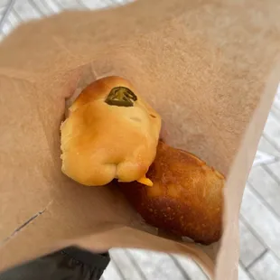 a person holding a bag of doughnuts