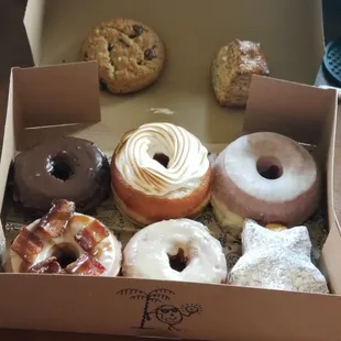 There was chocolate, maple bacon, plain glaze, plain cake, chocolate chip cookie, garlic herb biscuit, 2 unknown