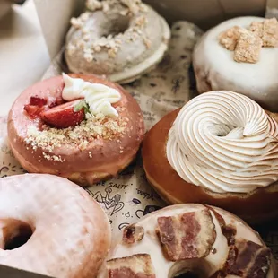 Blueberry Pancake, Strawberry Shortcake, Classic glazed, Maple Bacon, Toasted Coquito, Guava + Cheese
