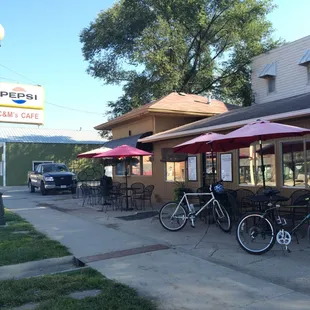 Storefront space features a bike rack and tables for outdoor dining.
