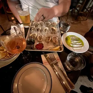 a man preparing a platter of oysters