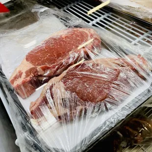 two pieces of meat wrapped in plastic