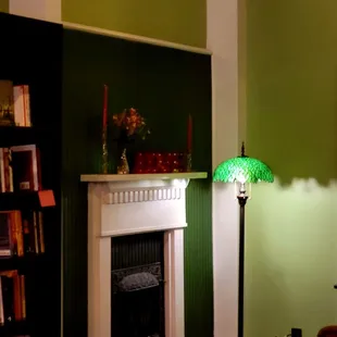 Cozy fireplace and reading lamp.