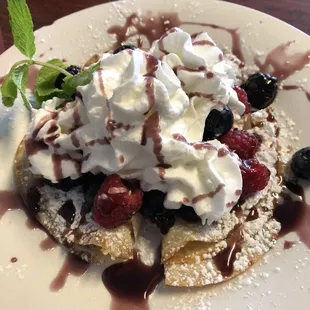 Blueberry raspberry crapes serve with bacon and eggs