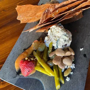 a platter of fruit, cheese, and crackers
