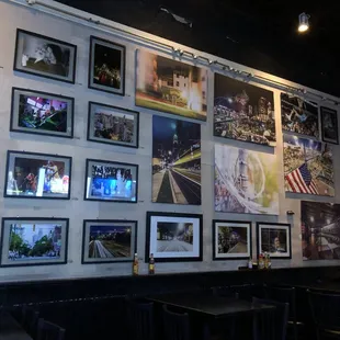 a wall full of pictures of the city