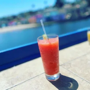 a glass of watermelon juice on a table
