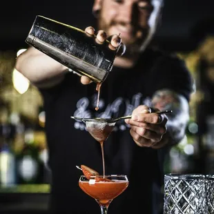 a bartender pouring a drink