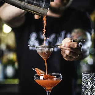 a bartender pouring a drink