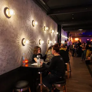 people sitting at tables in a restaurant