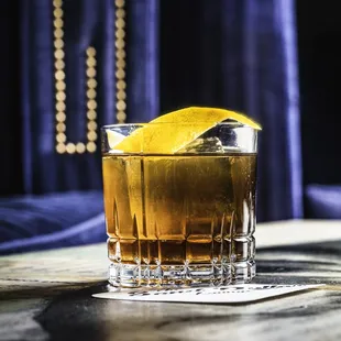 a glass of whiskey on a table