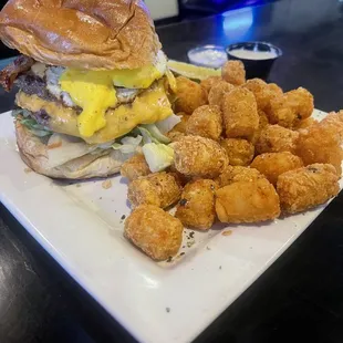 AM Burger with bacon and fried egg with tots.... Delicious
